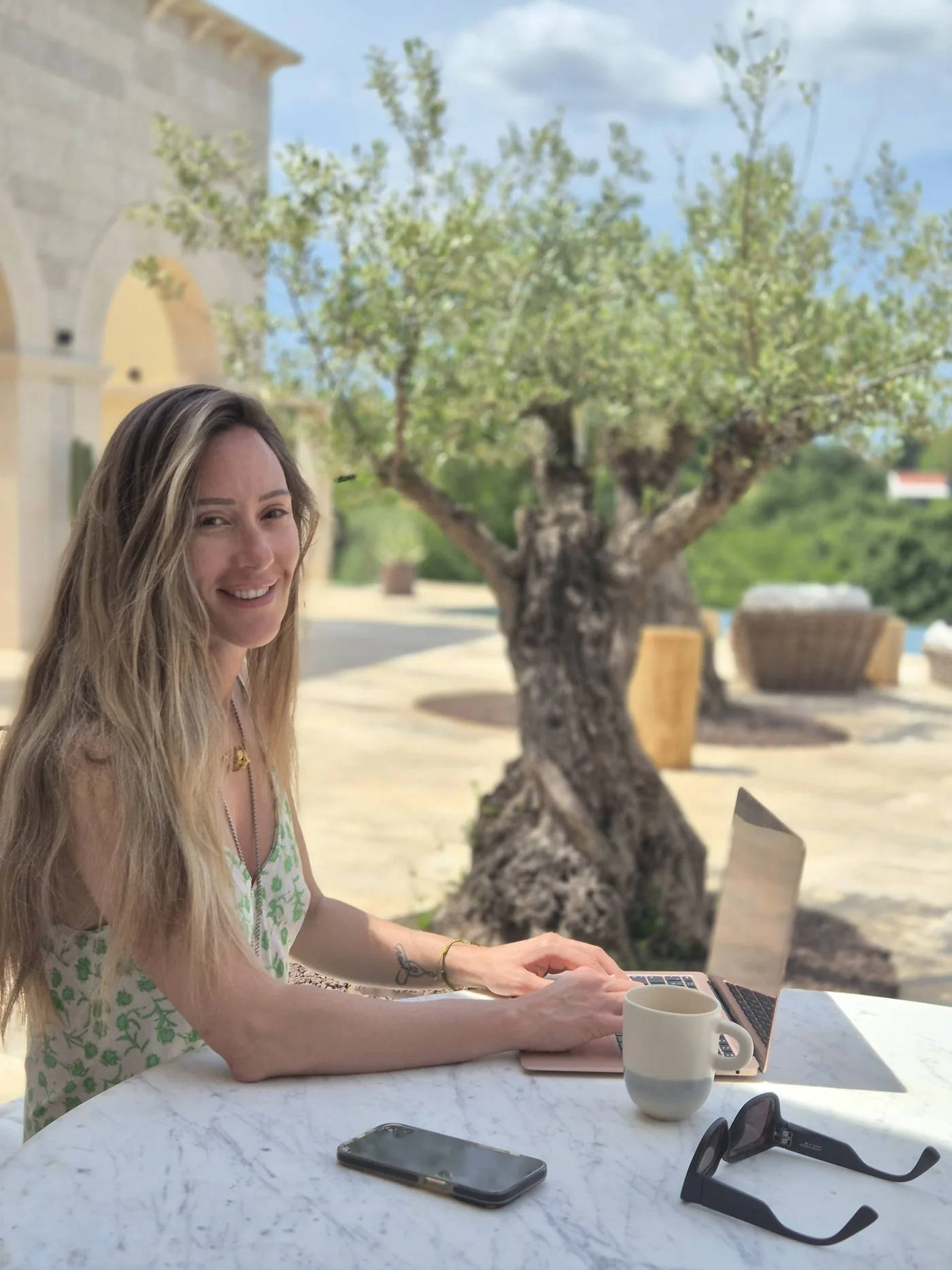 Andrea at LaMaison, at a table under the olive tree