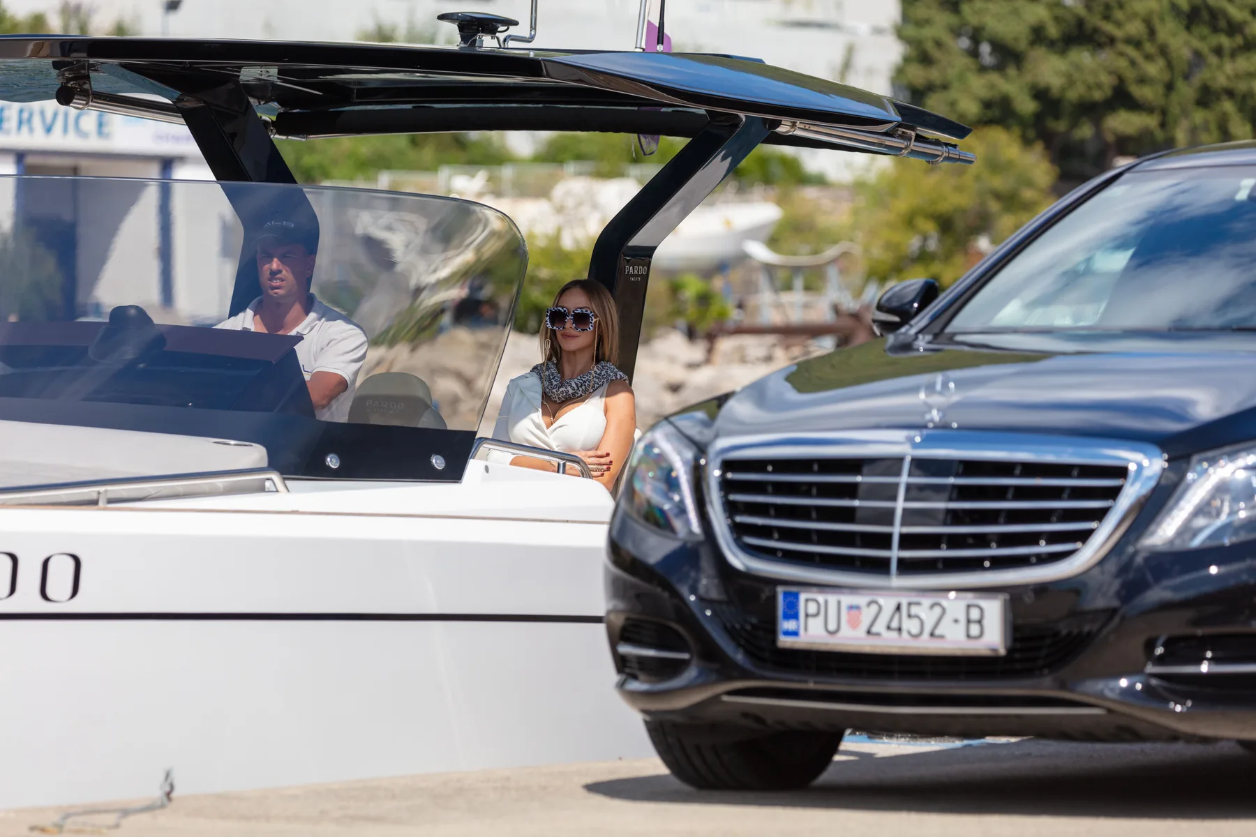 A Mercedes beside a private boat at the marina, a Belistria car and boat transfer in Istria