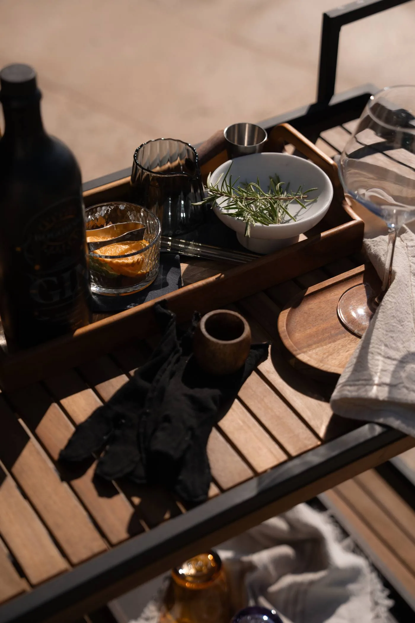 A tray of glasses and a LaMaison linen spray prepared at LaMaison