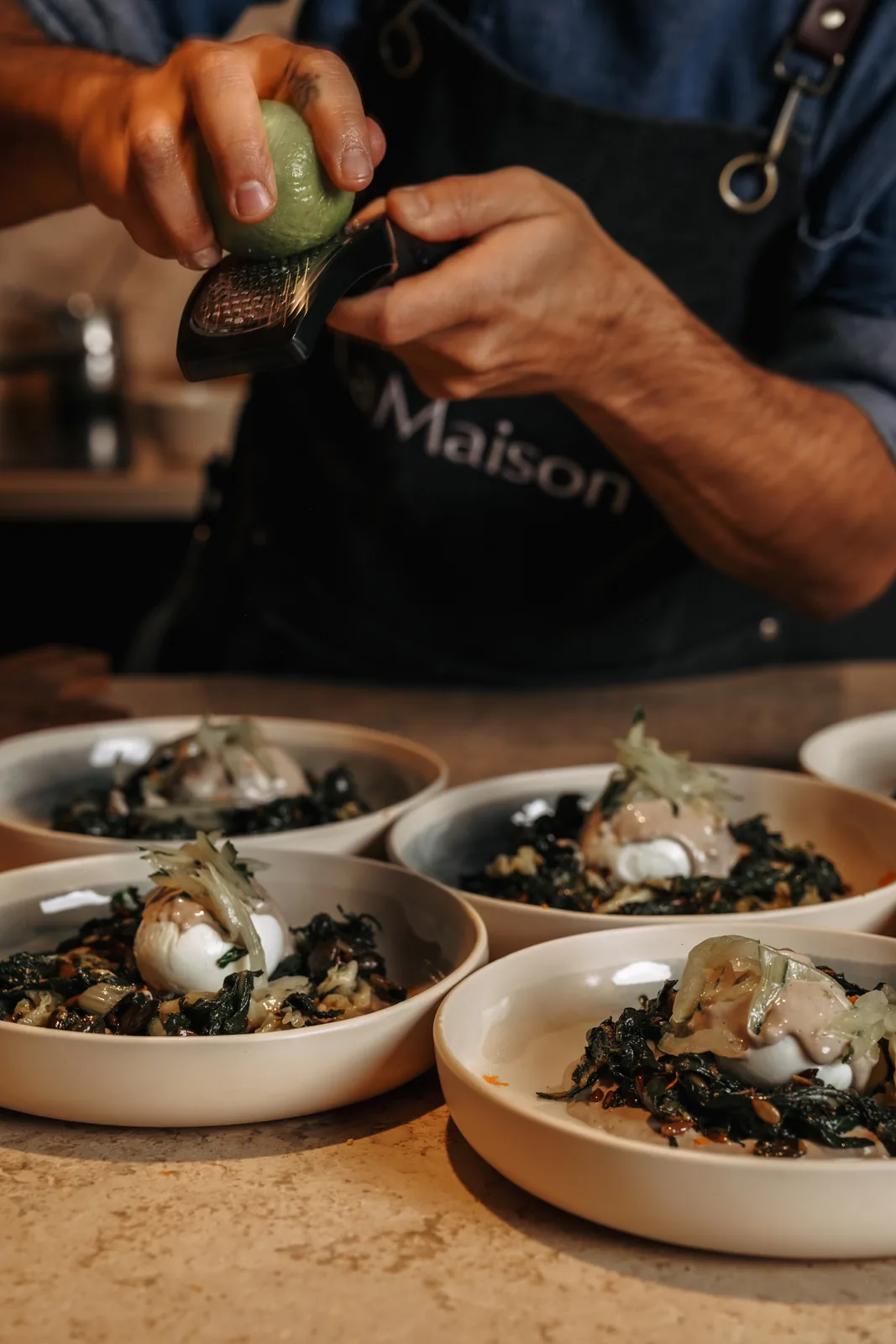 The chef finishing a dish at LaMaison