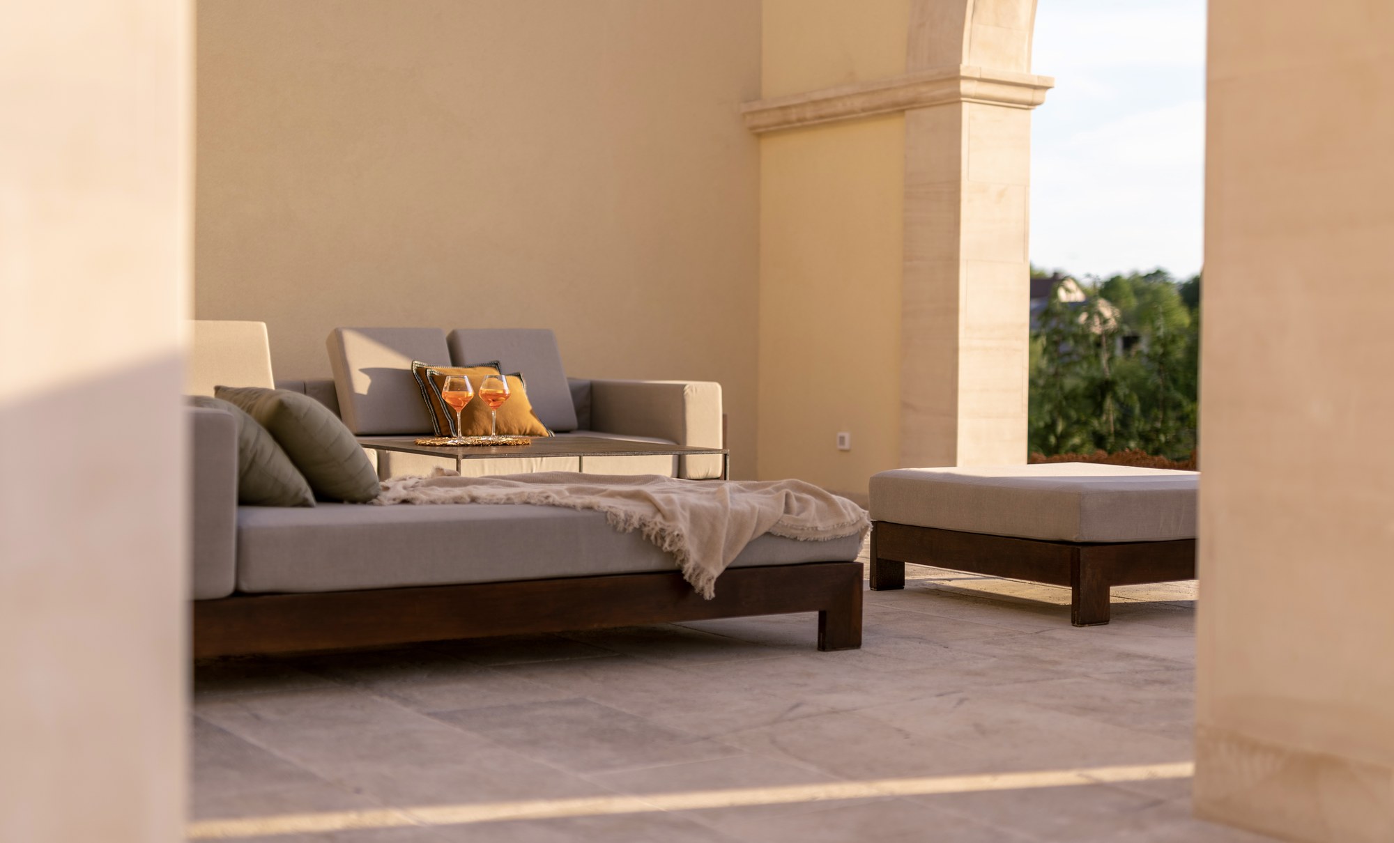 A shaded terrace and daybed at LaMaison, inland Istria, in the late afternoon light