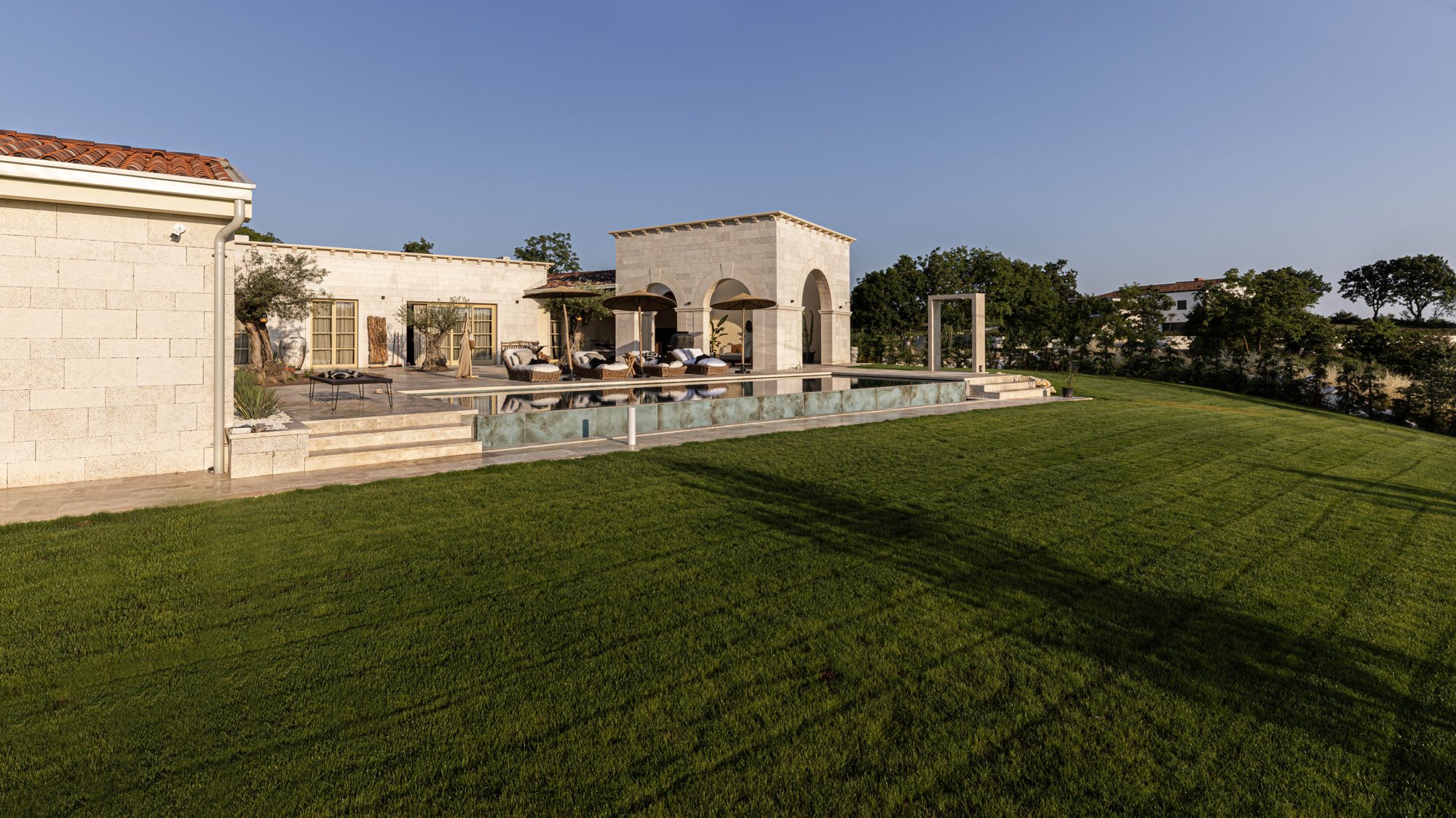 The residence, the loggia and the salty pool across the grounds at LaMaison